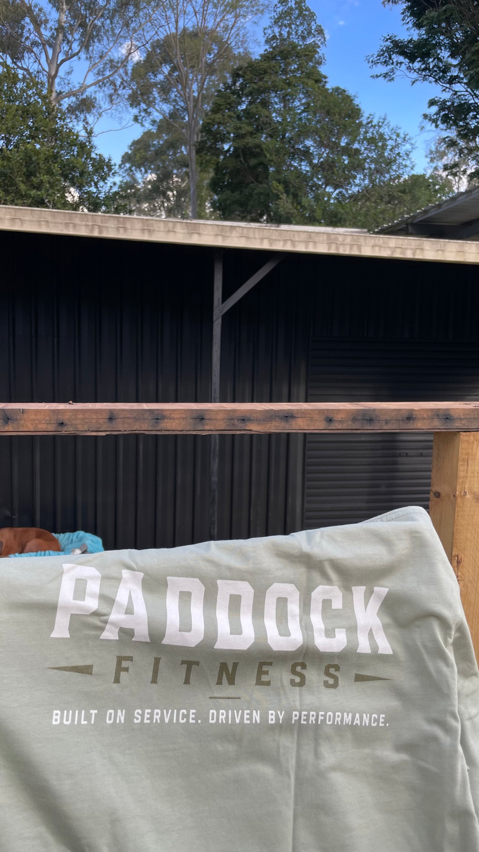 Paddock Fitness mens tee photographed at the rural training shed